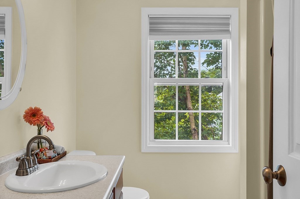 417 Hildreth Street, Unit 3 Lowell, MA 01850 - Photo 30 of 37 a bathroom with a sink a mirror and a window