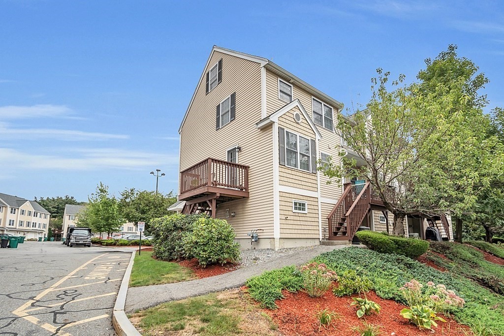 417 Hildreth Street, Unit 3 Lowell, MA 01850 - Photo 36 of 37 a front view of a house with a yard