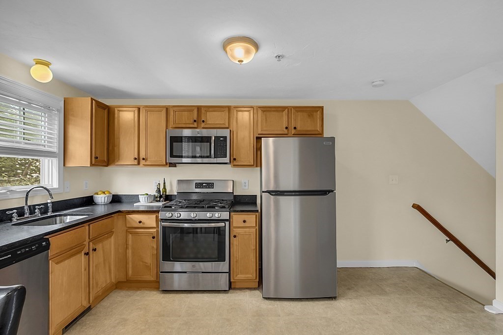 417 Hildreth Street, Unit 3 Lowell, MA 01850 - Photo 7 of 37 a kitchen with a refrigerator sink and stove
