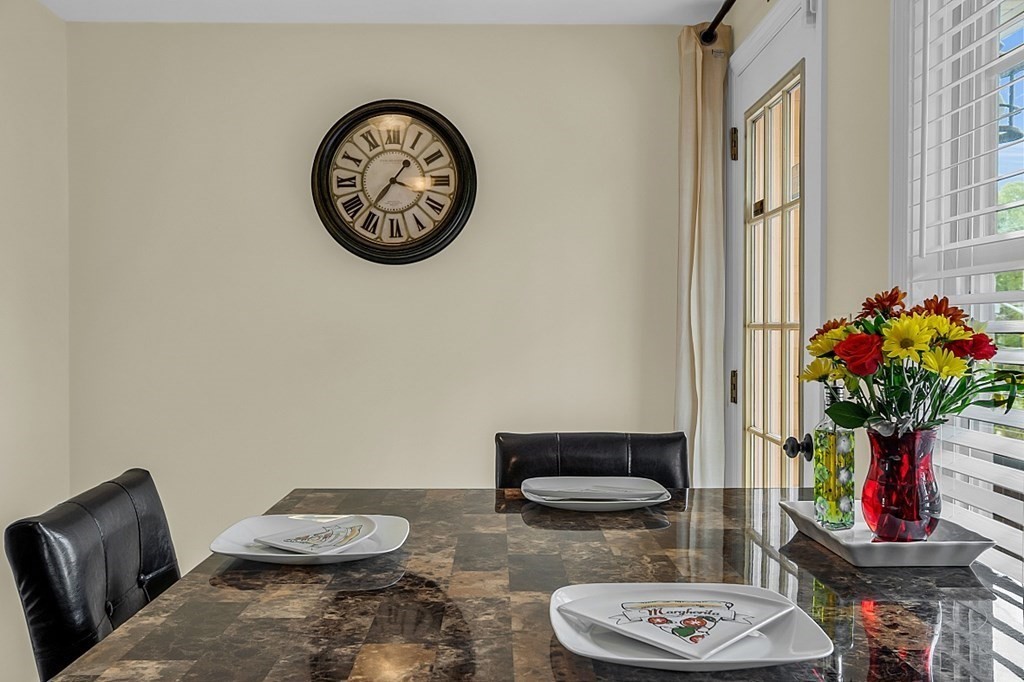 417 Hildreth Street, Unit 3 Lowell, MA 01850 - Photo 8 of 37 a view of a dining room with furniture and wooden floor