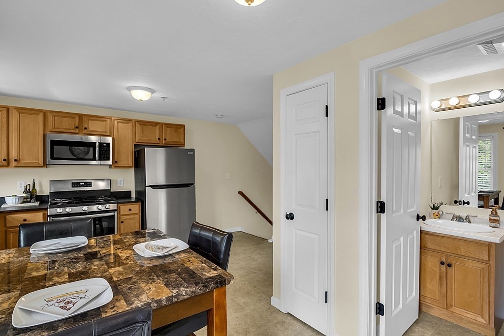 417 Hildreth Street, Unit 3 Lowell, MA 01850 - Photo 10 of 37 a kitchen with stainless steel appliances granite countertop a sink stove and refrigerator