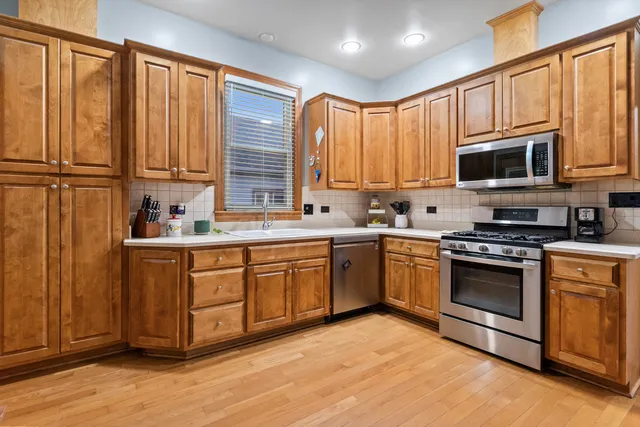 a kitchen with granite countertop a refrigerator stove and microwave