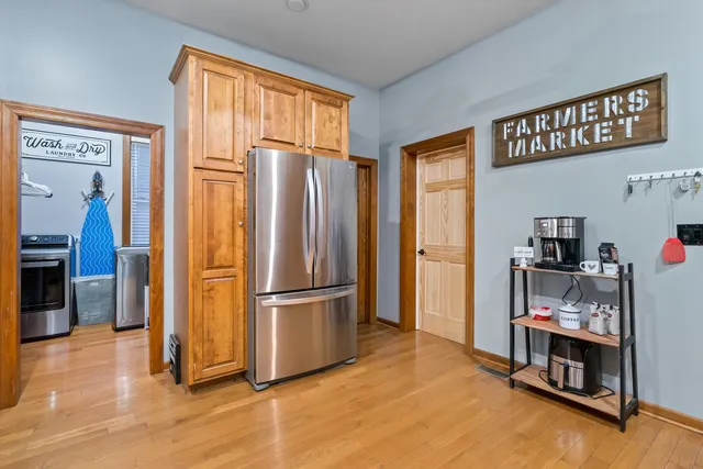 a kitchen with stainless steel appliances a refrigerator and a stove top oven