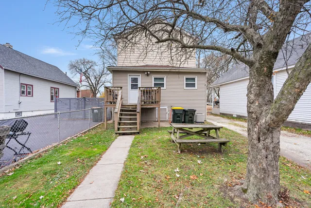 a white bench sitting in front of a house