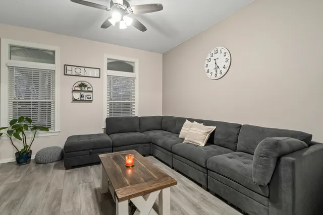 a living room with furniture and a wooden floor