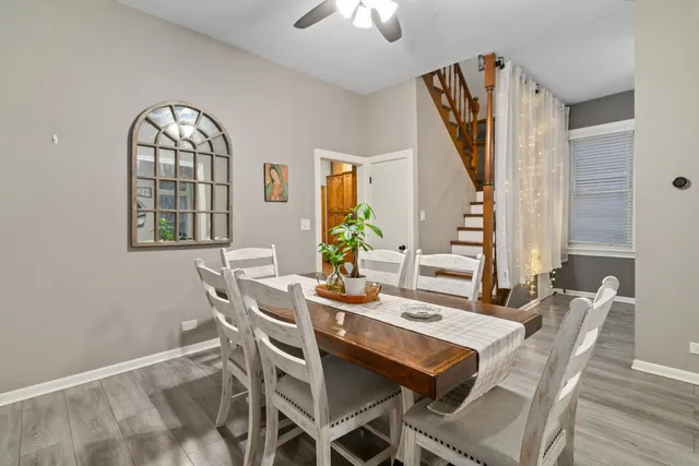 a view of a dining room with furniture and chandelier