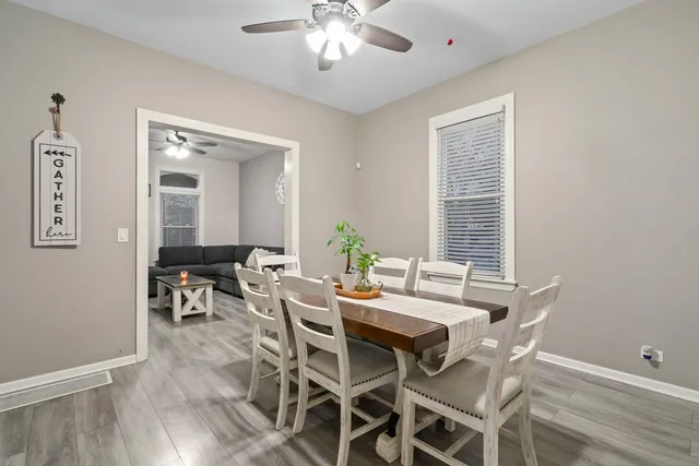 a view of a dining room with furniture and wooden floor