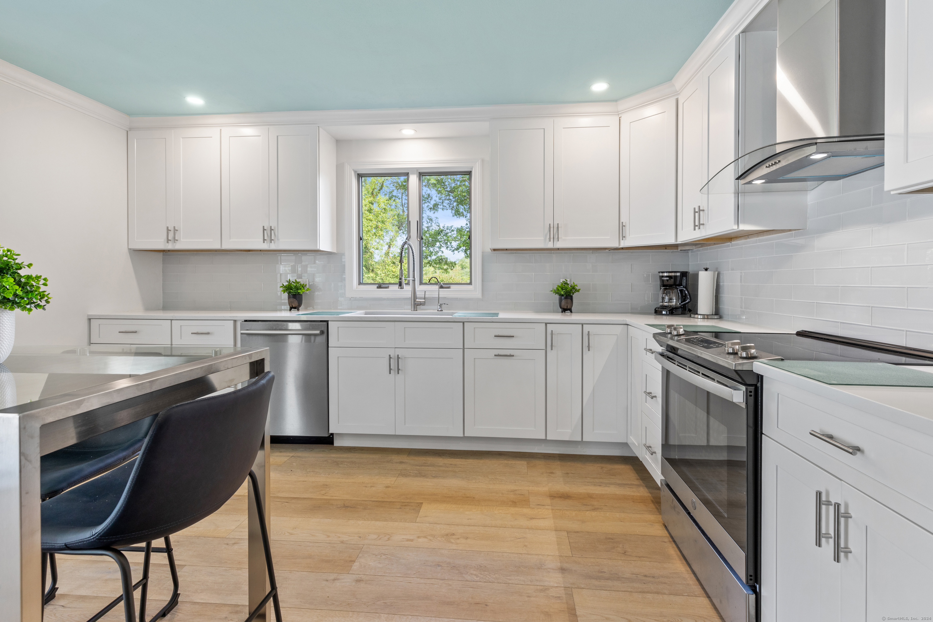72 Cherry Lane Madison, CT 06443 - Photo 11 of 40 a kitchen that has a sink and a stove in it