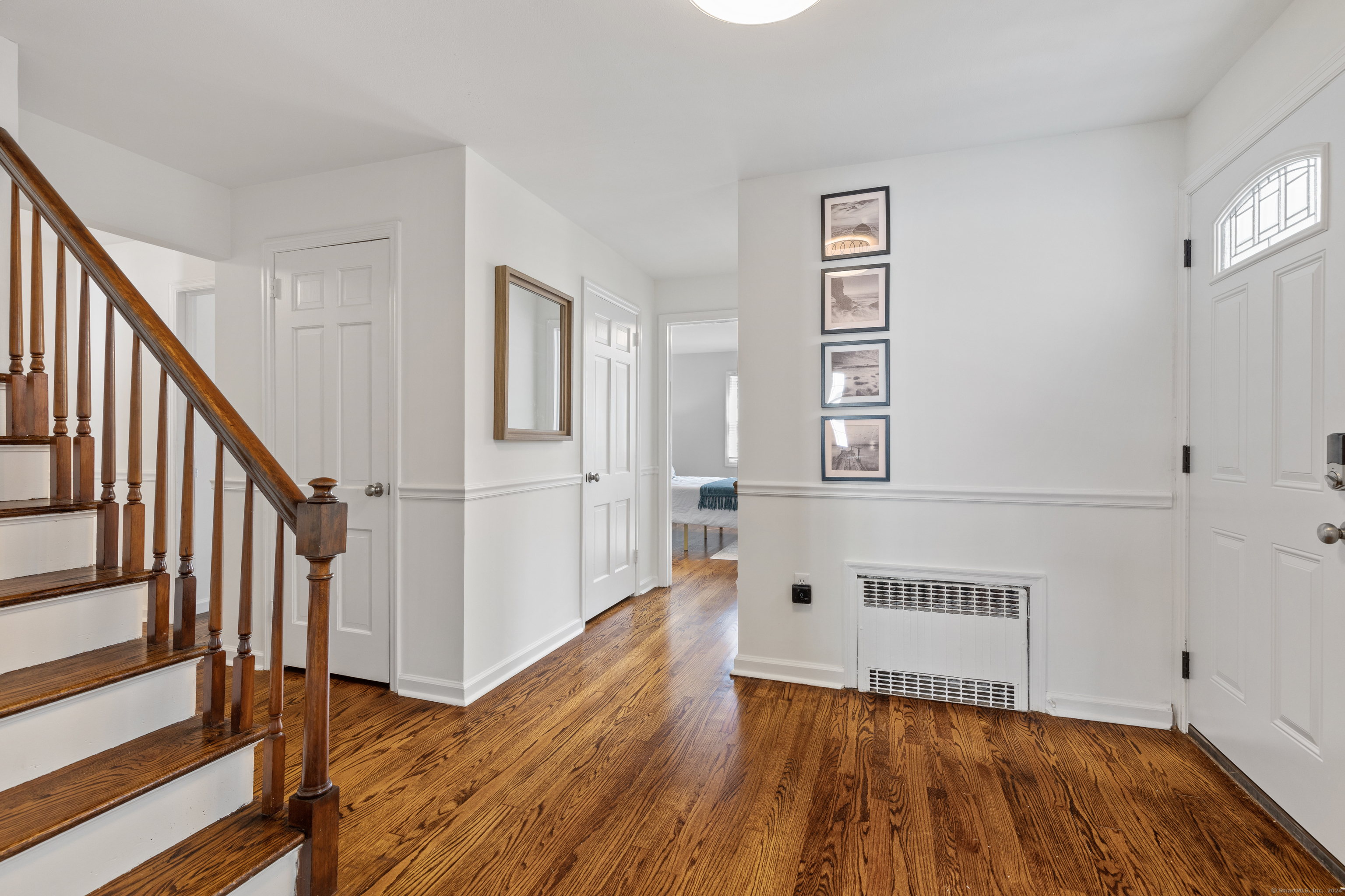 72 Cherry Lane Madison, CT 06443 - Photo 14 of 40 a view of a hallway with wooden floor and staircase