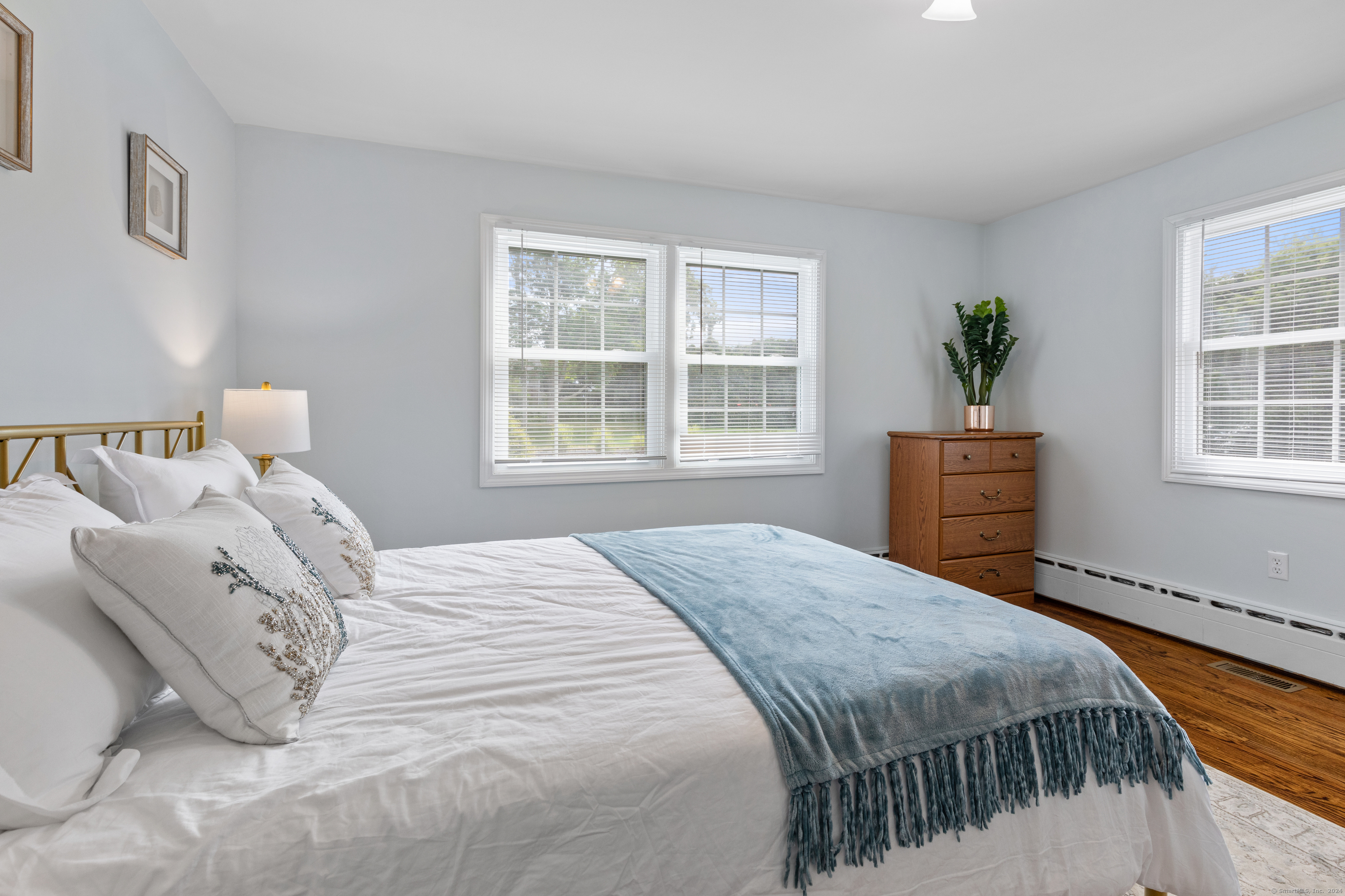 72 Cherry Lane Madison, CT 06443 - Photo 16 of 40 a bedroom with a bed a dresser and next to a window