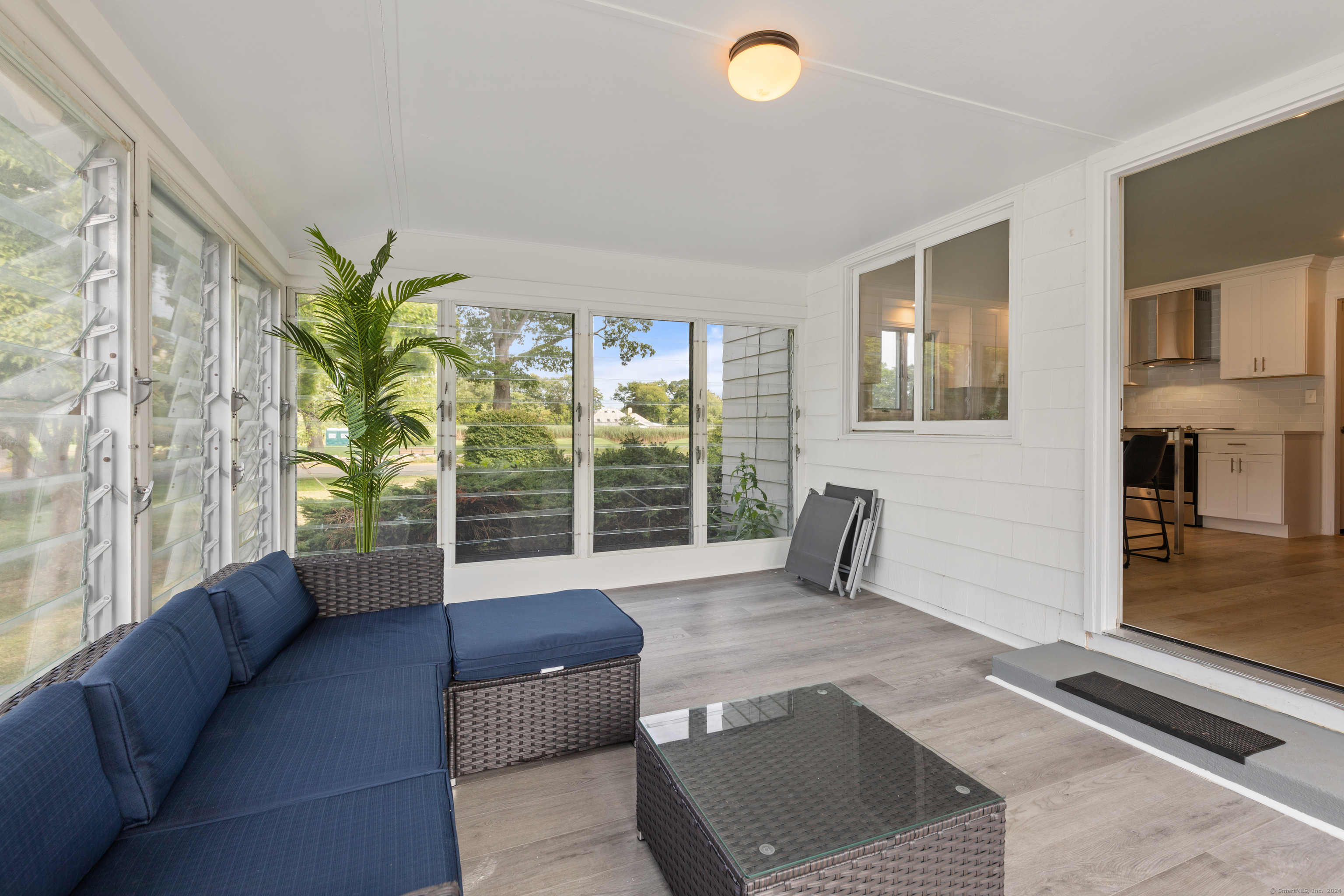 72 Cherry Lane Madison, CT 06443 - Photo 26 of 40 a living room with furniture and a potted plant