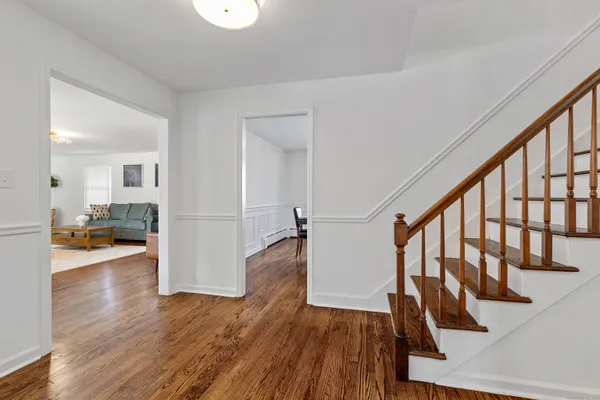 a view of entryway with wooden floor and stairs