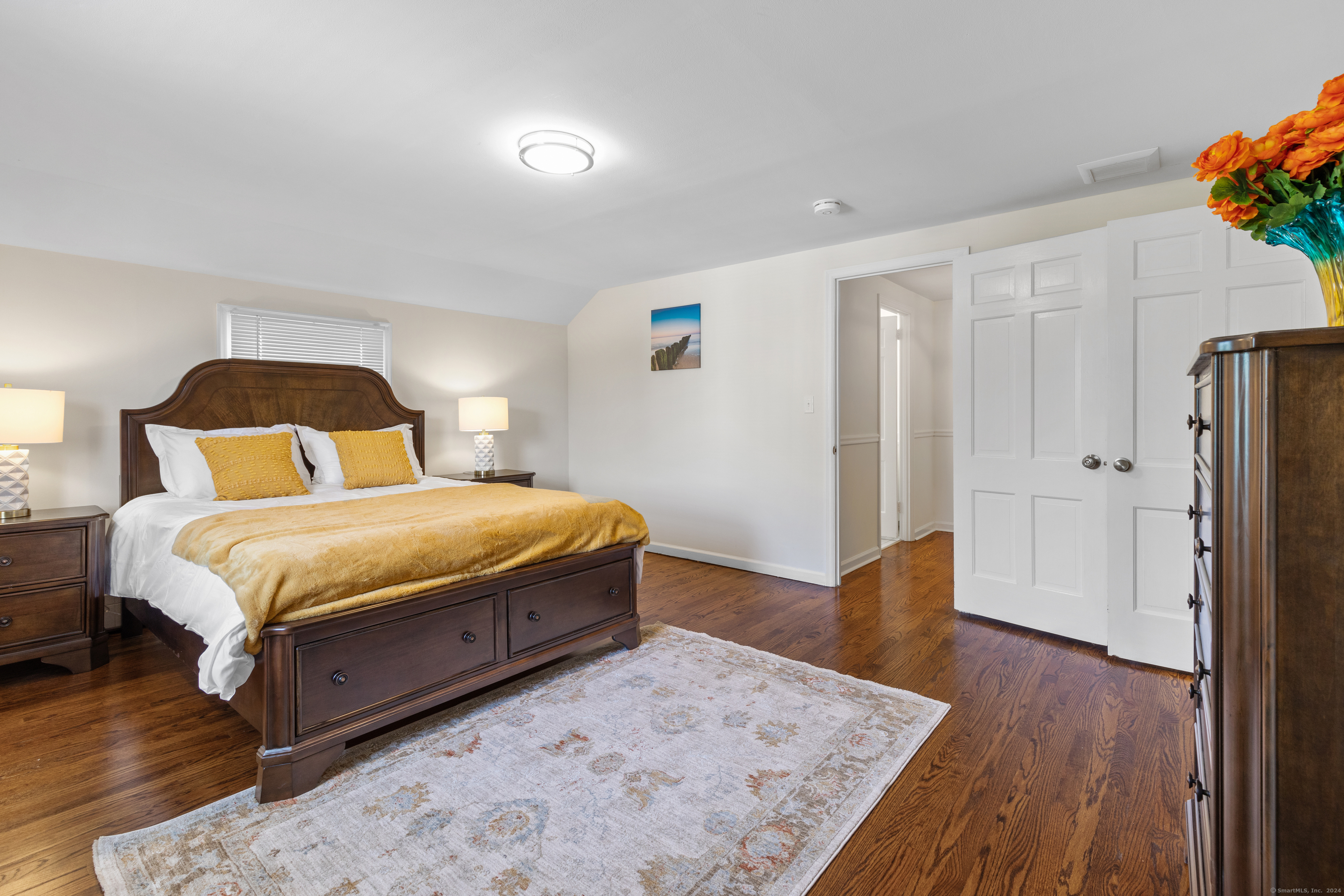 72 Cherry Lane Madison, CT 06443 - Photo 28 of 40 a bedroom with a bed and wooden floor