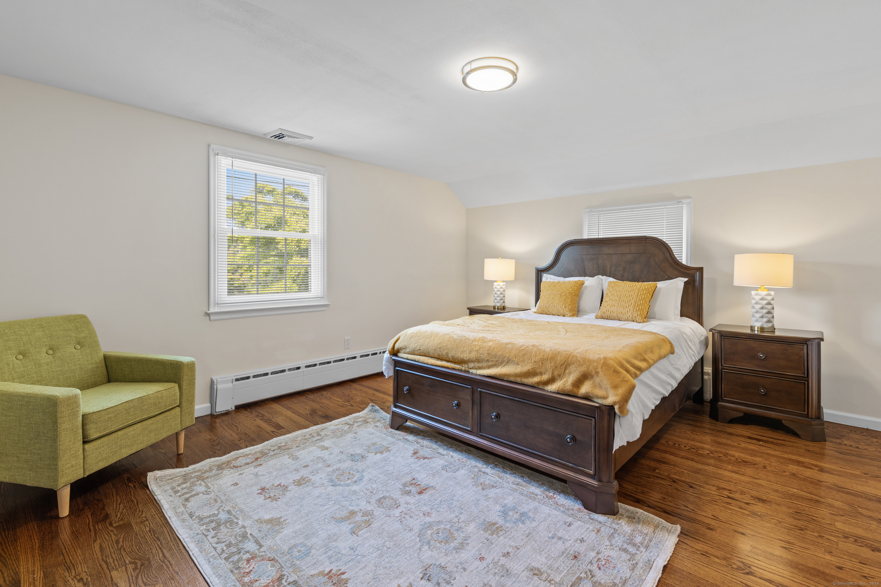 72 Cherry Lane Madison, CT 06443 - Photo 29 of 40 a bedroom with a bed and wooden floor