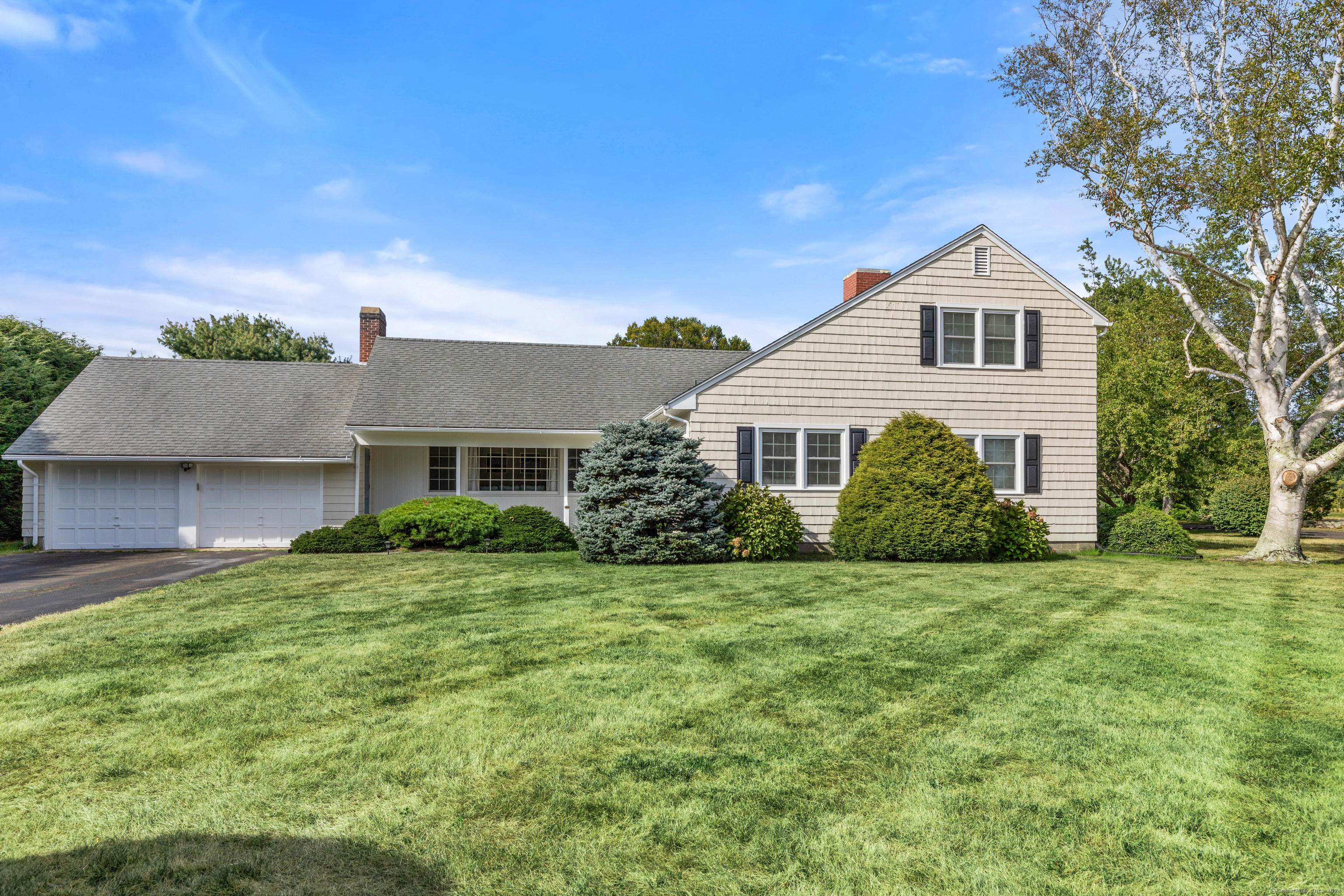 72 Cherry Lane Madison, CT 06443 - Photo 3 of 40 a view of a house with a big yard potted plants and large tree