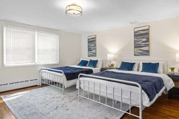 a bedroom with two beds and a window