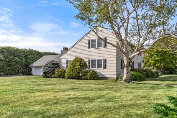 a front view of house with yard and green space