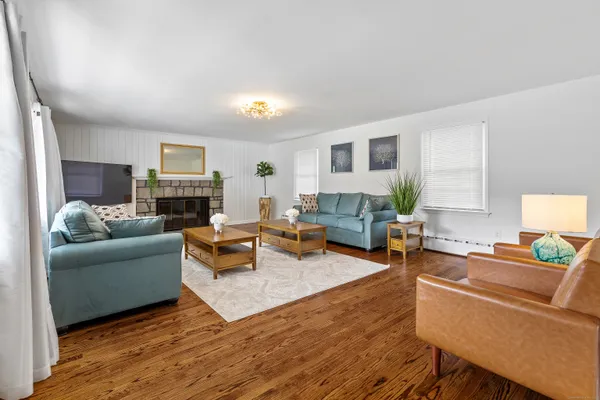 a living room with furniture and a wooden floor