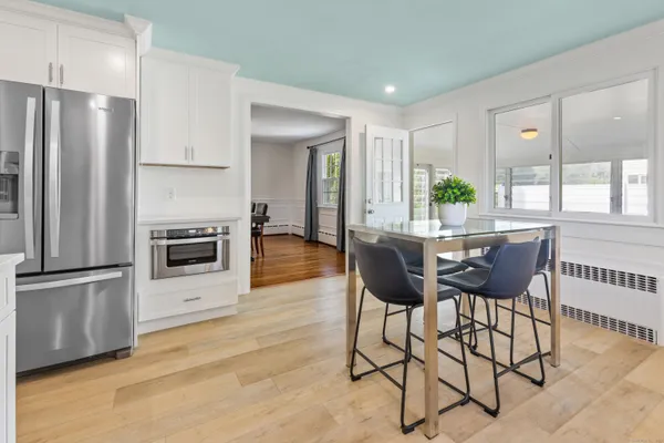 a dining room with furniture and a kitchen view