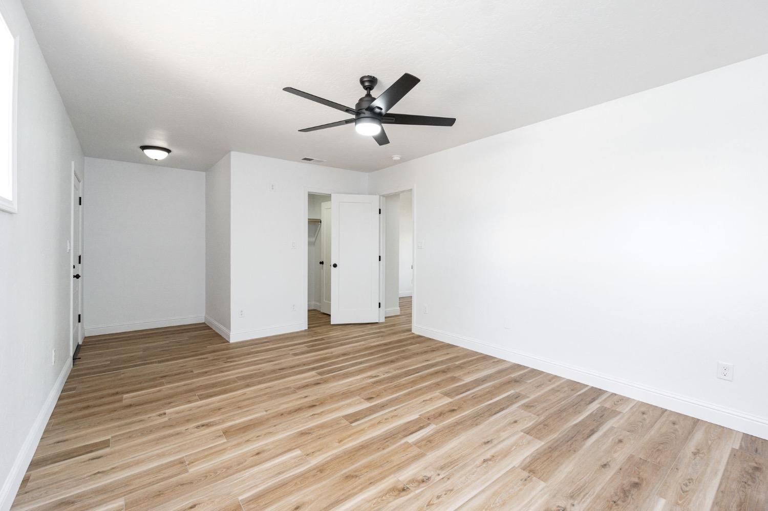 133 South Reed Avenue Reedley, CA 93654 - Photo 23 of 42 a view of a big room with wooden floor and windows in a room
