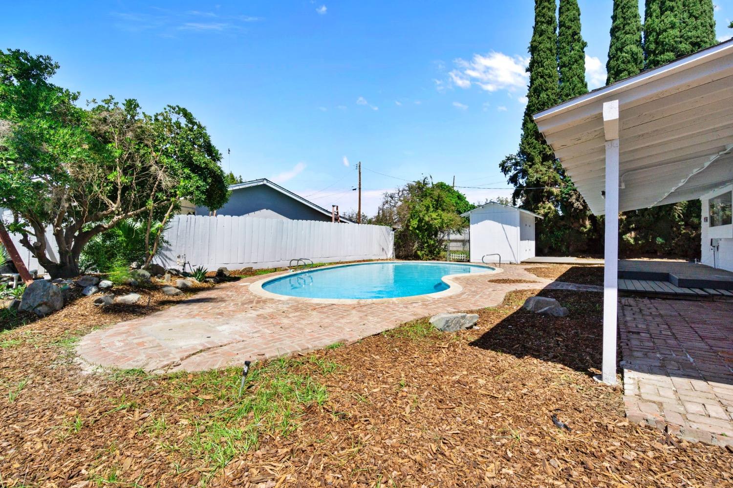 133 South Reed Avenue Reedley, CA 93654 - Photo 33 of 42 a view of a house with backyard and sitting area