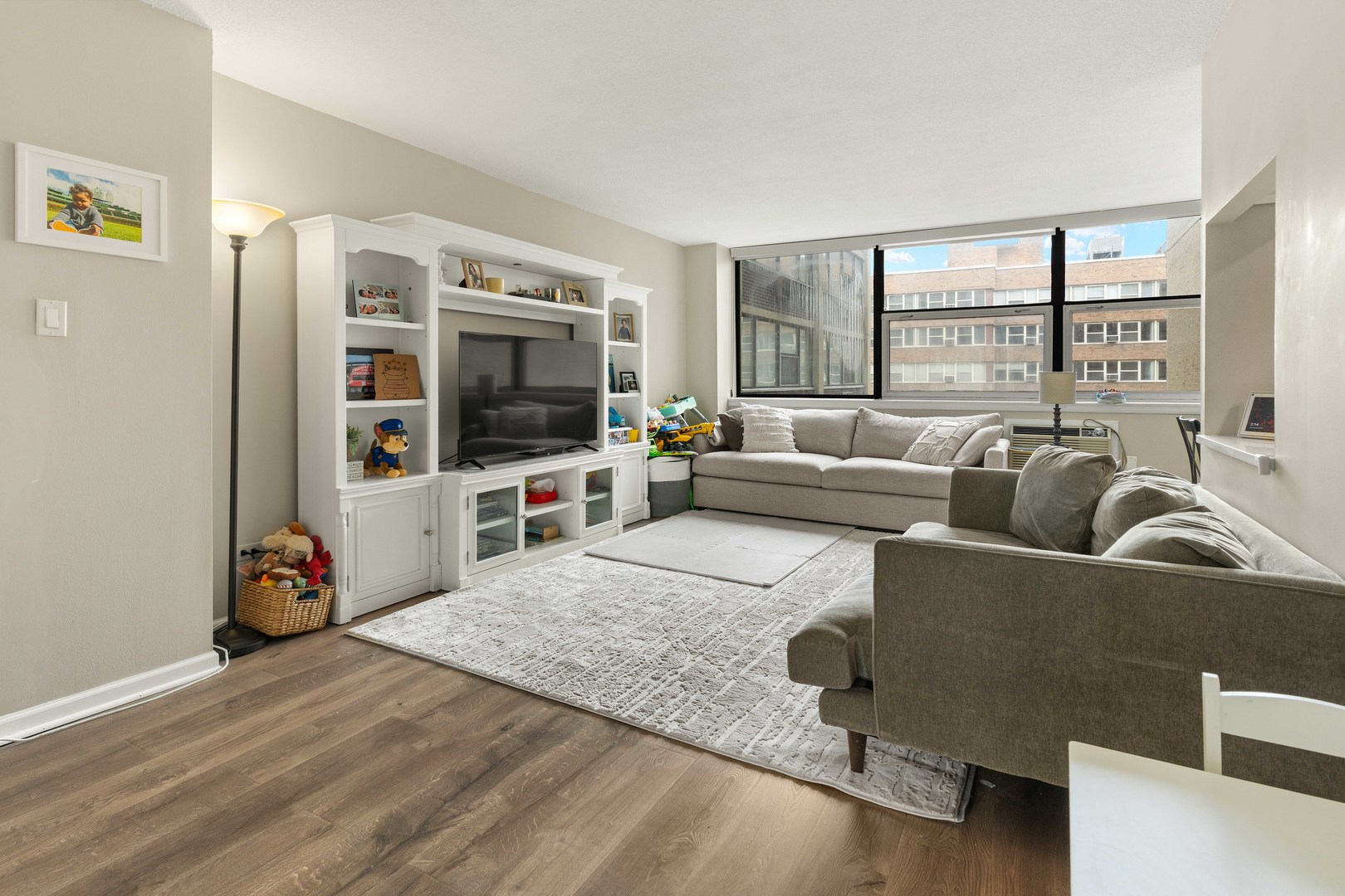 3110 North Sheridan Road, Unit 1205 Chicago, IL 60657 - Photo 3 of 21 a living room with furniture and a flat screen tv