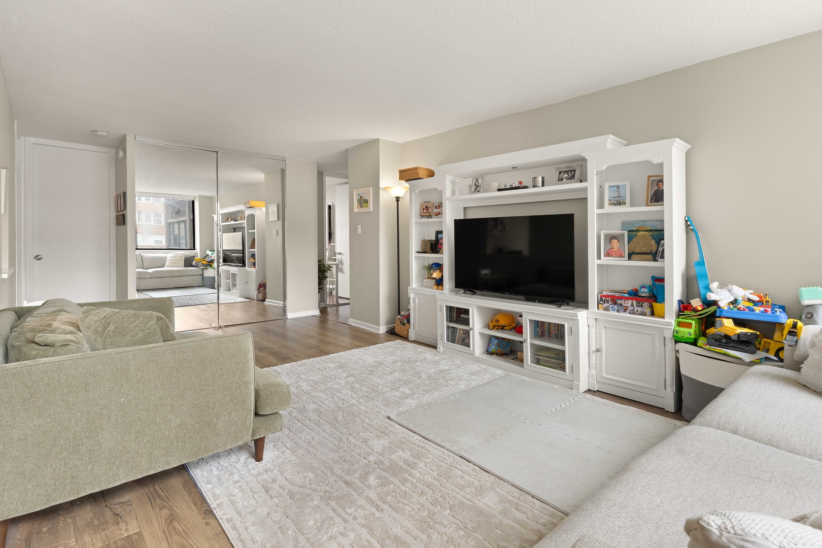 3110 North Sheridan Road, Unit 1205 Chicago, IL 60657 - Photo 4 of 21 a living room with furniture and a flat screen tv