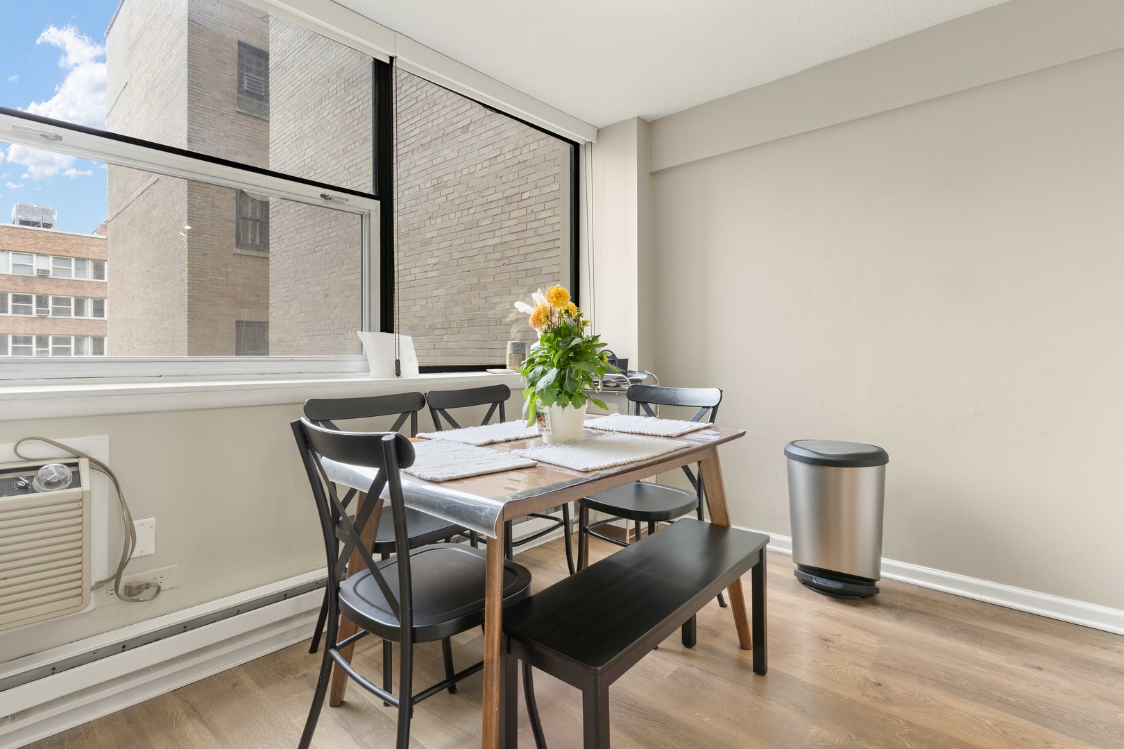 3110 North Sheridan Road, Unit 1205 Chicago, IL 60657 - Photo 8 of 21 a view of a dining room with furniture and a potted plant