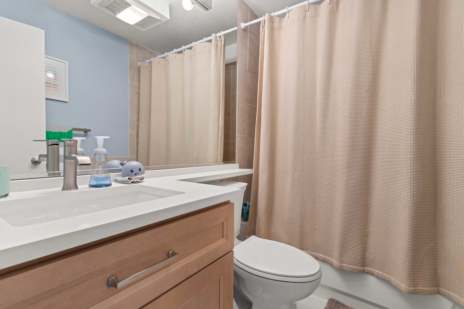 3110 North Sheridan Road, Unit 1205 Chicago, IL 60657 - Photo 9 of 21 a bathroom with a granite countertop sink and a mirror