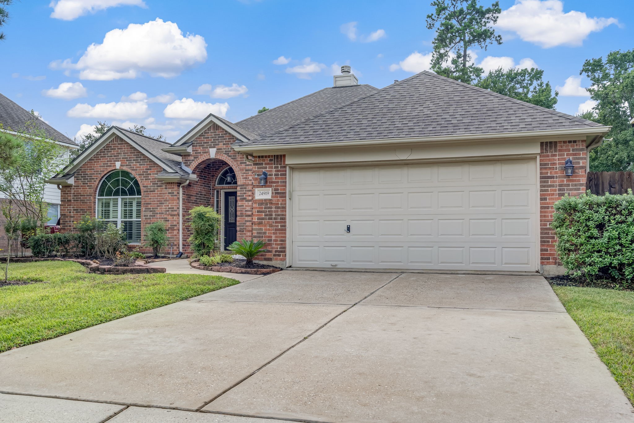 24919 Corbin Gate Drive Spring, TX 77389 - Photo 29 of 29 a front view of a house with a yard and garage