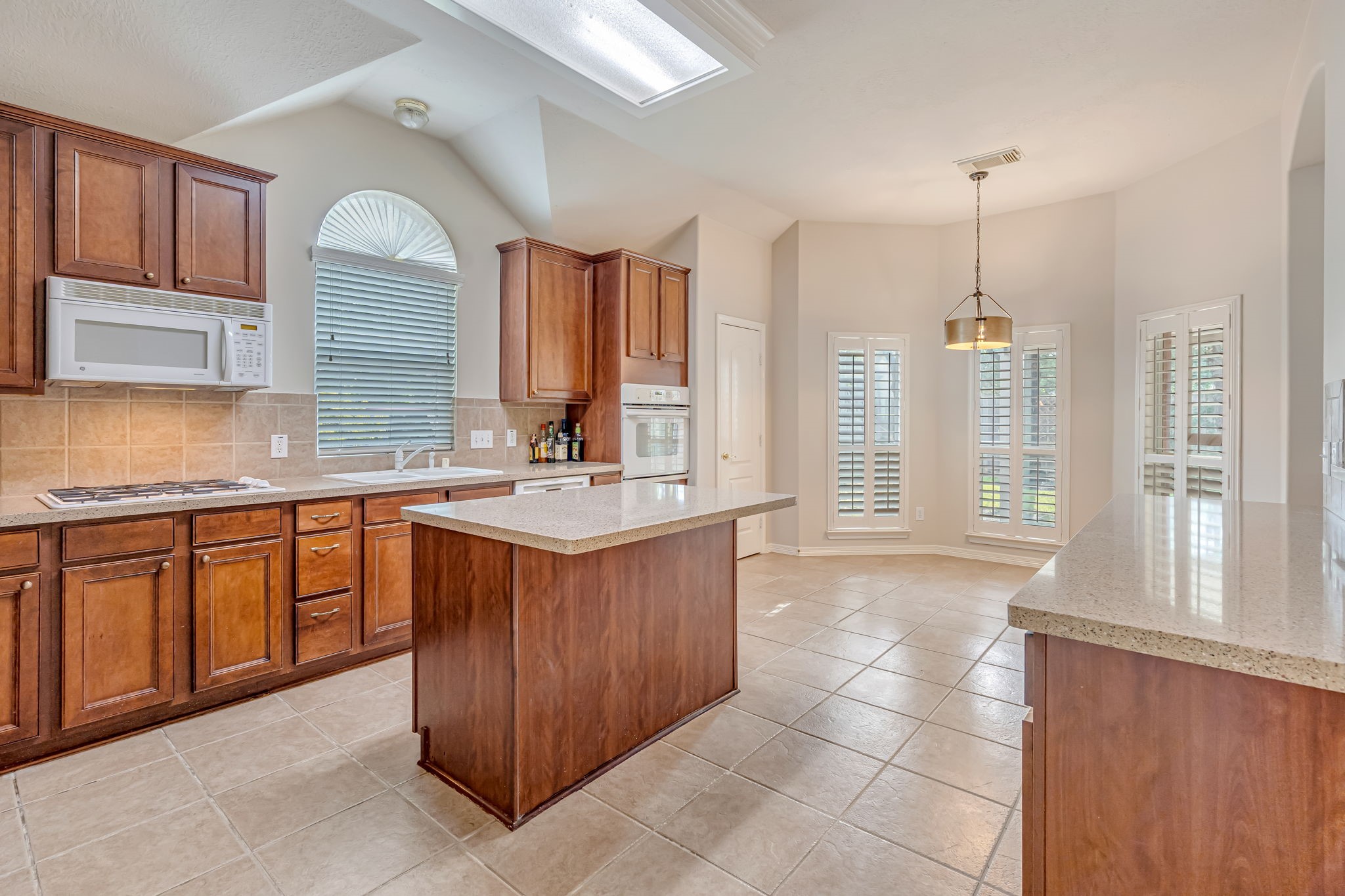24919 Corbin Gate Drive Spring, TX 77389 - Photo 9 of 29 a kitchen with stainless steel appliances granite countertop a sink and cabinets