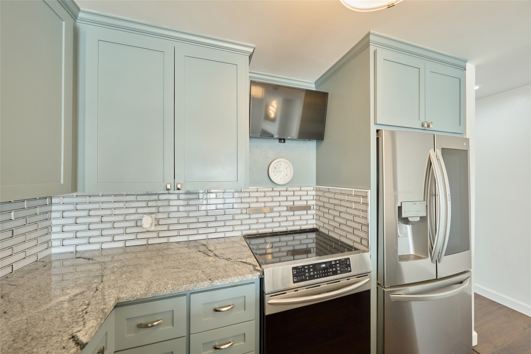 801 River Road, Unit E111 Montgomery, TX 77356 - Photo 12 of 24 a kitchen with a refrigerator and a stove top oven