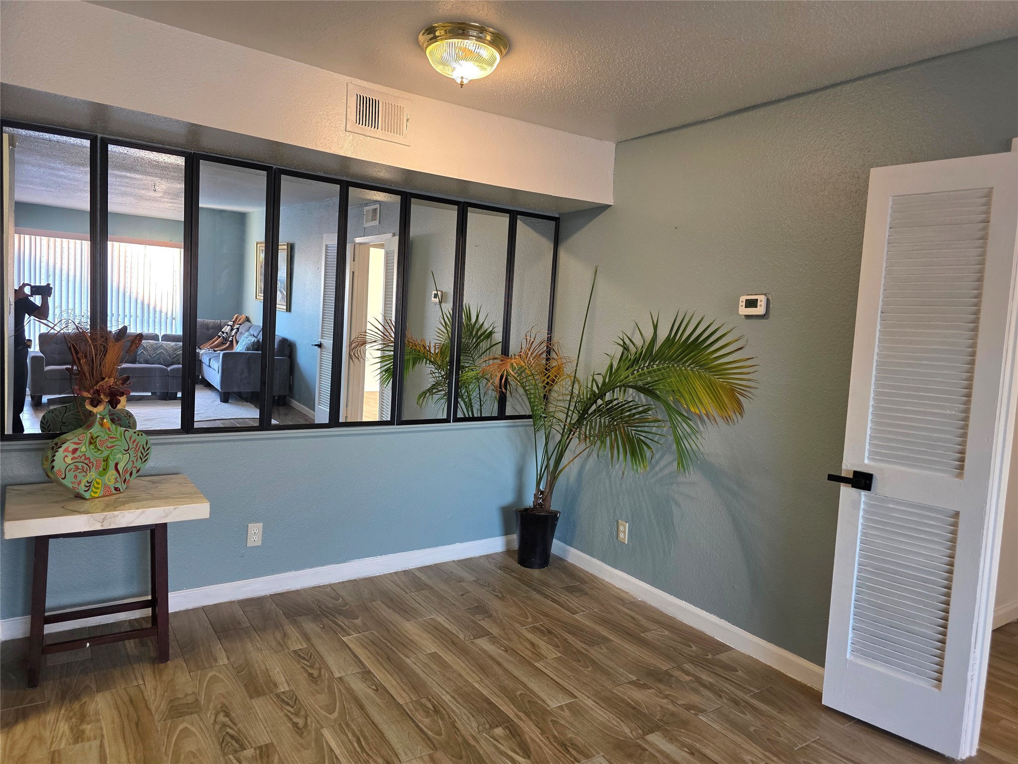 6200 West Tidwell Road, Unit 1702 Houston, TX 77092 - Photo 6 of 24 a room with window and wooden floor