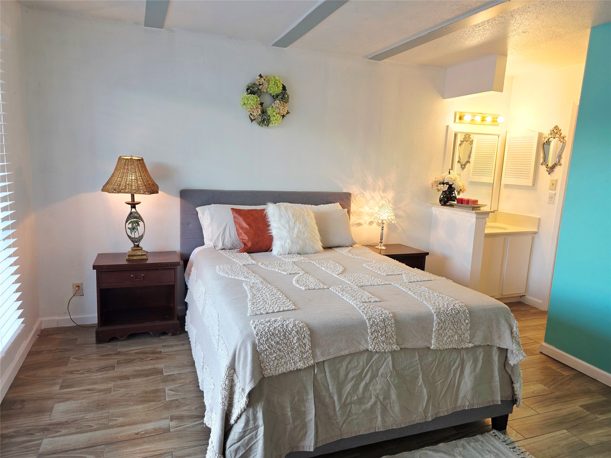 6200 West Tidwell Road, Unit 1702 Houston, TX 77092 - Photo 8 of 24 a bedroom with a bed and wooden floor