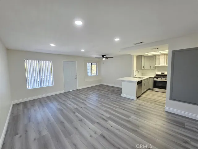 a view of kitchen with wooden floor electronic appliances and window