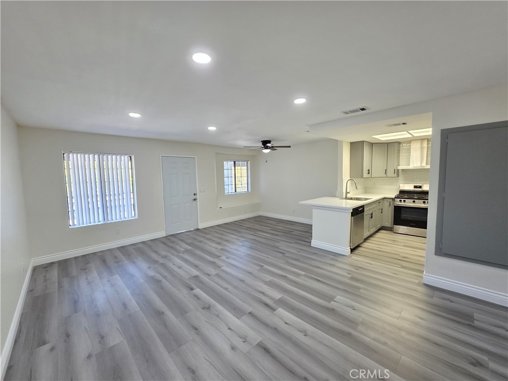 44036 25th Street West, Unit B7 Lancaster, CA 93536 - Photo 1 of 20 a view of kitchen with wooden floor electronic appliances and window