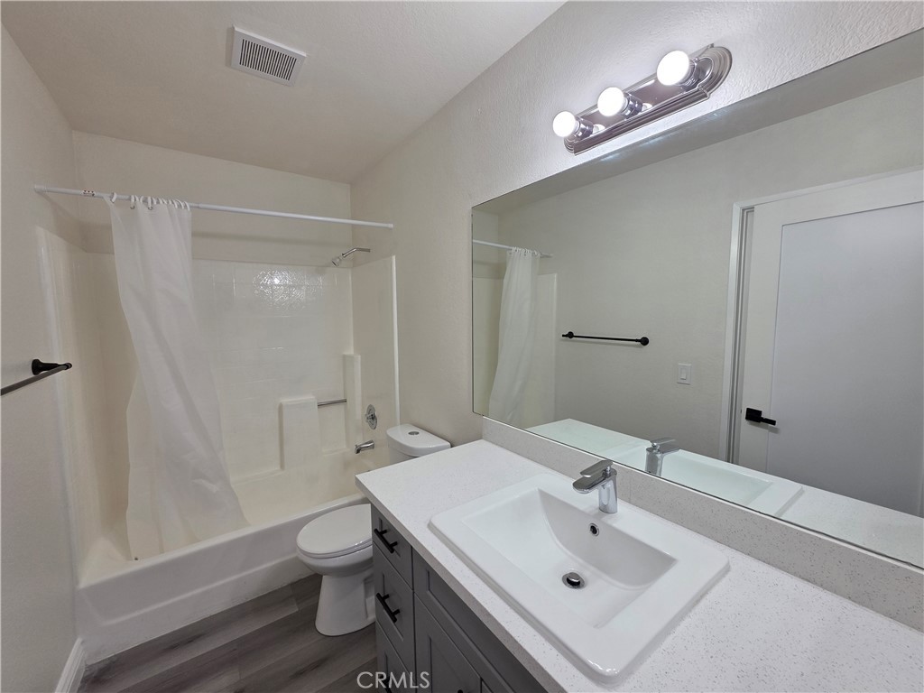 44036 25th Street West, Unit B7 Lancaster, CA 93536 - Photo 11 of 20 a bathroom with a sink a toilet and shower