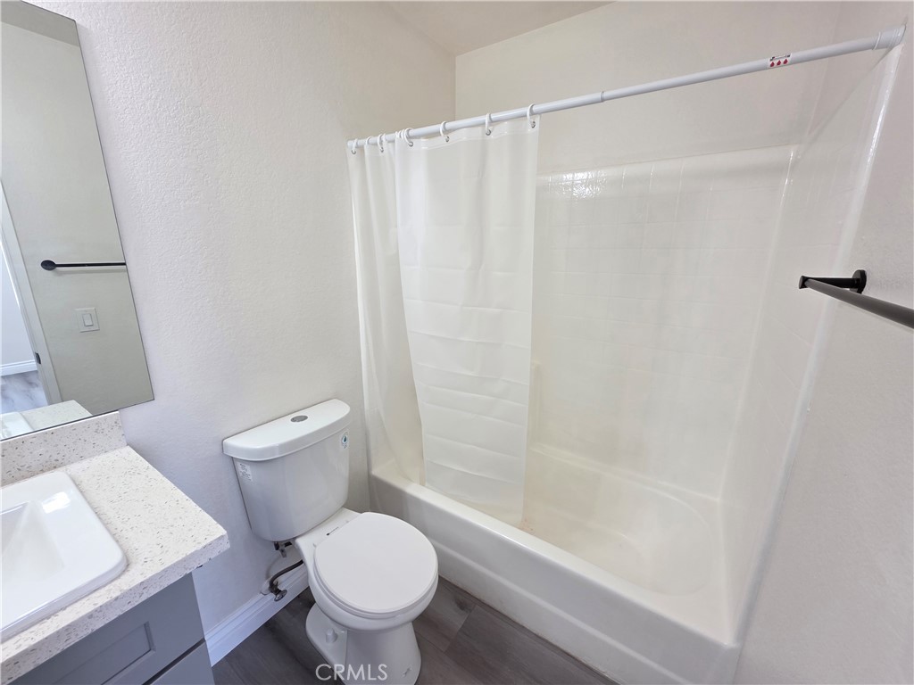 44036 25th Street West, Unit B7 Lancaster, CA 93536 - Photo 12 of 20 a white toilet sitting next to a bath tub