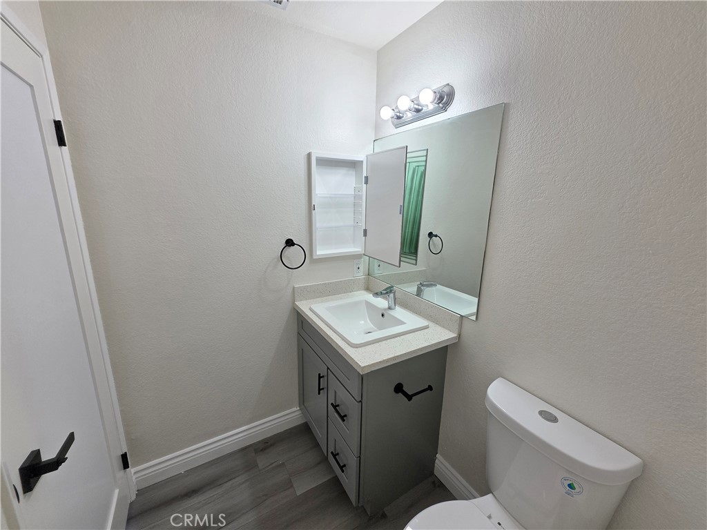 44036 25th Street West, Unit B7 Lancaster, CA 93536 - Photo 13 of 20 a bathroom with a toilet sink and mirror