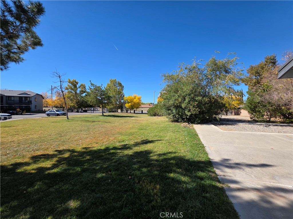 44036 25th Street West, Unit B7 Lancaster, CA 93536 - Photo 20 of 20 a view of outdoor space with garden and trees