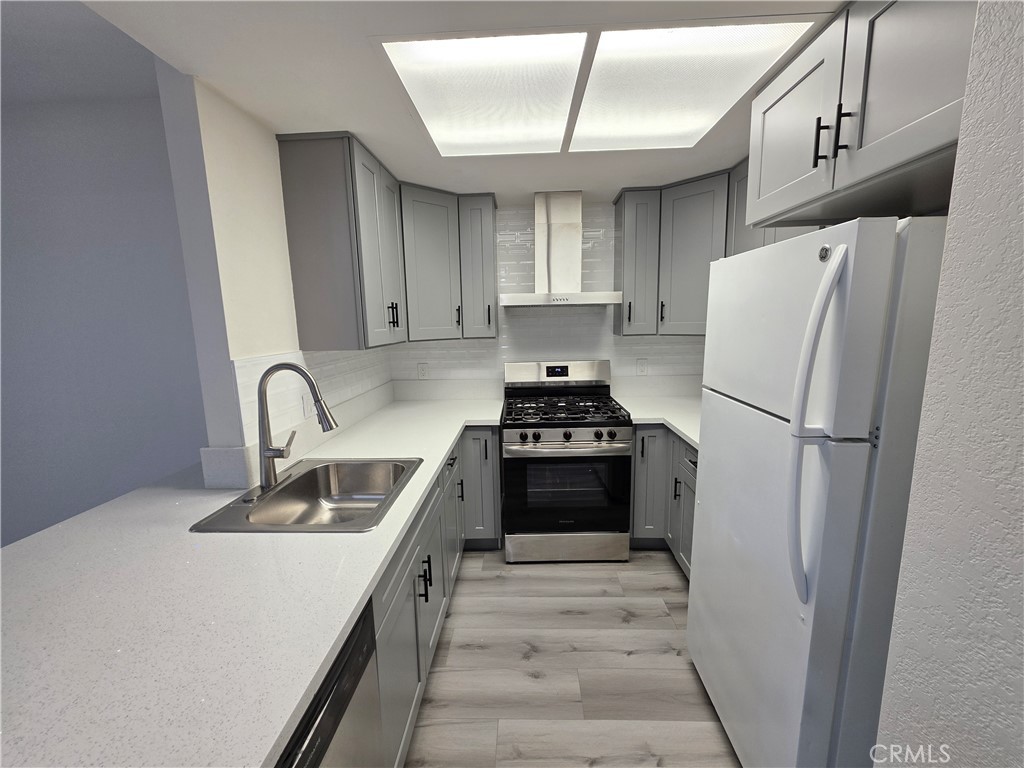 44036 25th Street West, Unit B7 Lancaster, CA 93536 - Photo 3 of 20 a kitchen with stainless steel appliances a refrigerator sink and cabinets