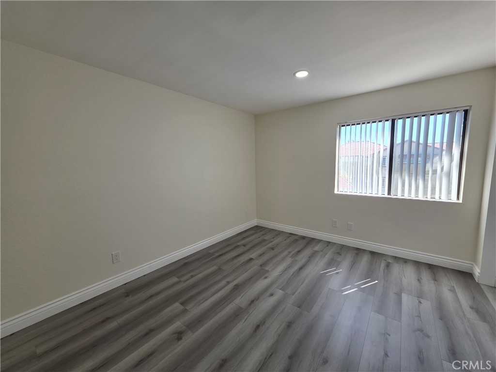 44036 25th Street West, Unit B7 Lancaster, CA 93536 - Photo 8 of 20 wooden floor in an empty room with a window