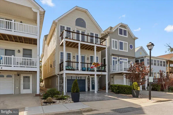 a front view of a residential apartment building with a yard
