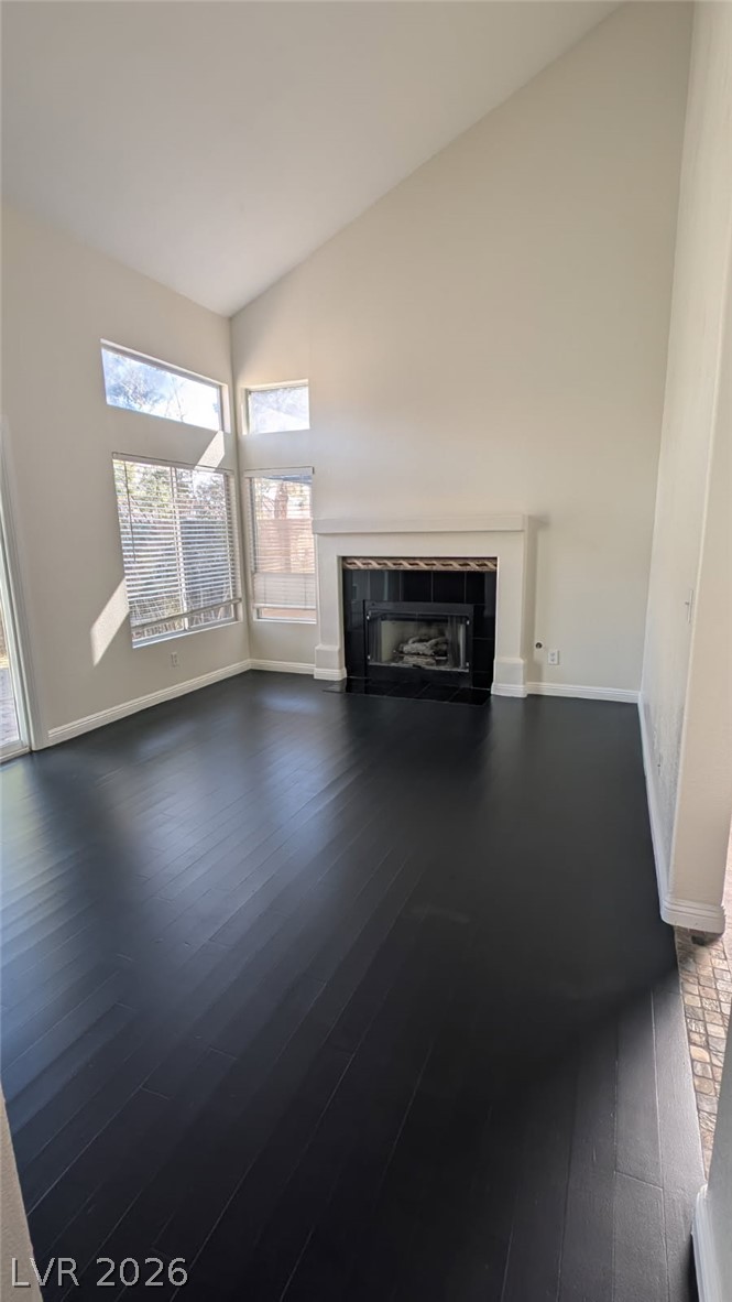 2670 Ridgewater Circle Henderson, NV 89074 - Photo 5 of 22 A spacious living room features soaring vaulted ceilings and a classic fireplace, perfect for gathering.