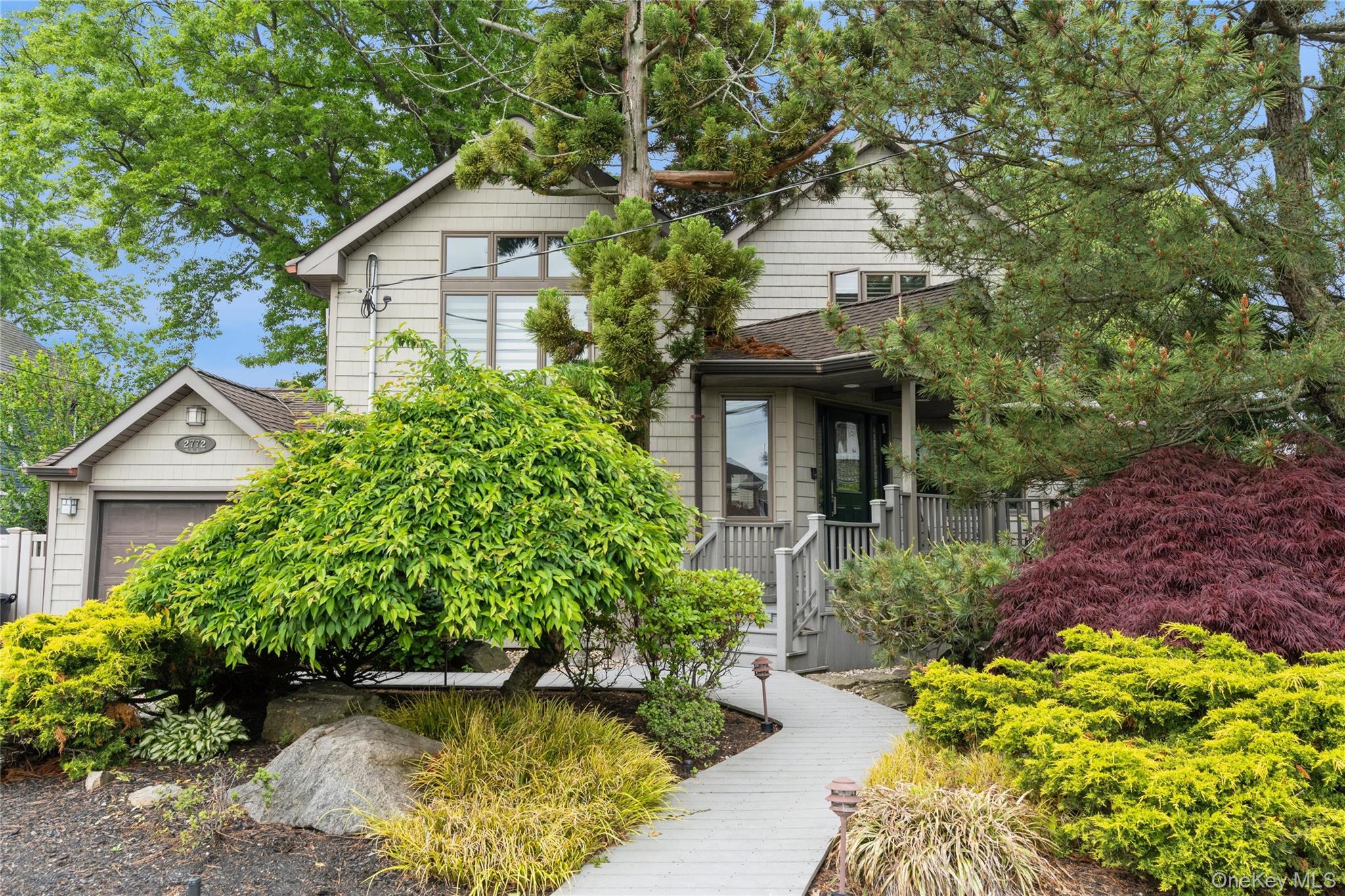2772 Riverside Avenue Merrick, NY 11566 - Photo 43 of 45 a front view of a house with a garden