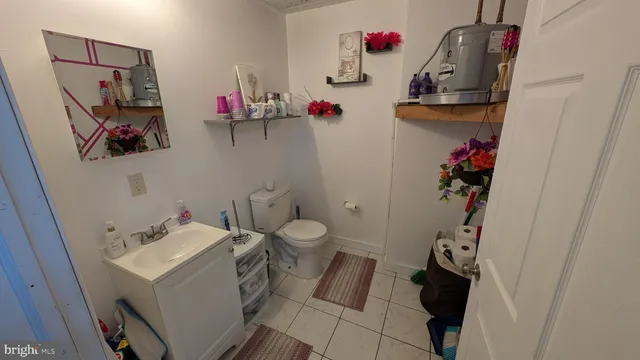 a bathroom with a sink mirror and toilet