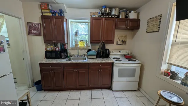 a spacious bathroom with a granite countertop sink a vanity and a mirror