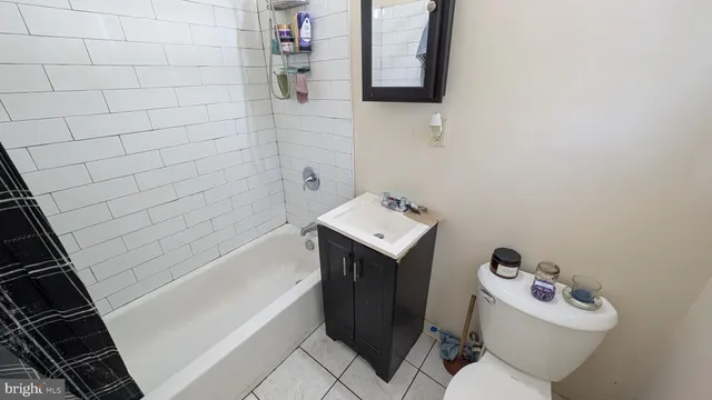 a bathroom with a sink toilet and bathtub