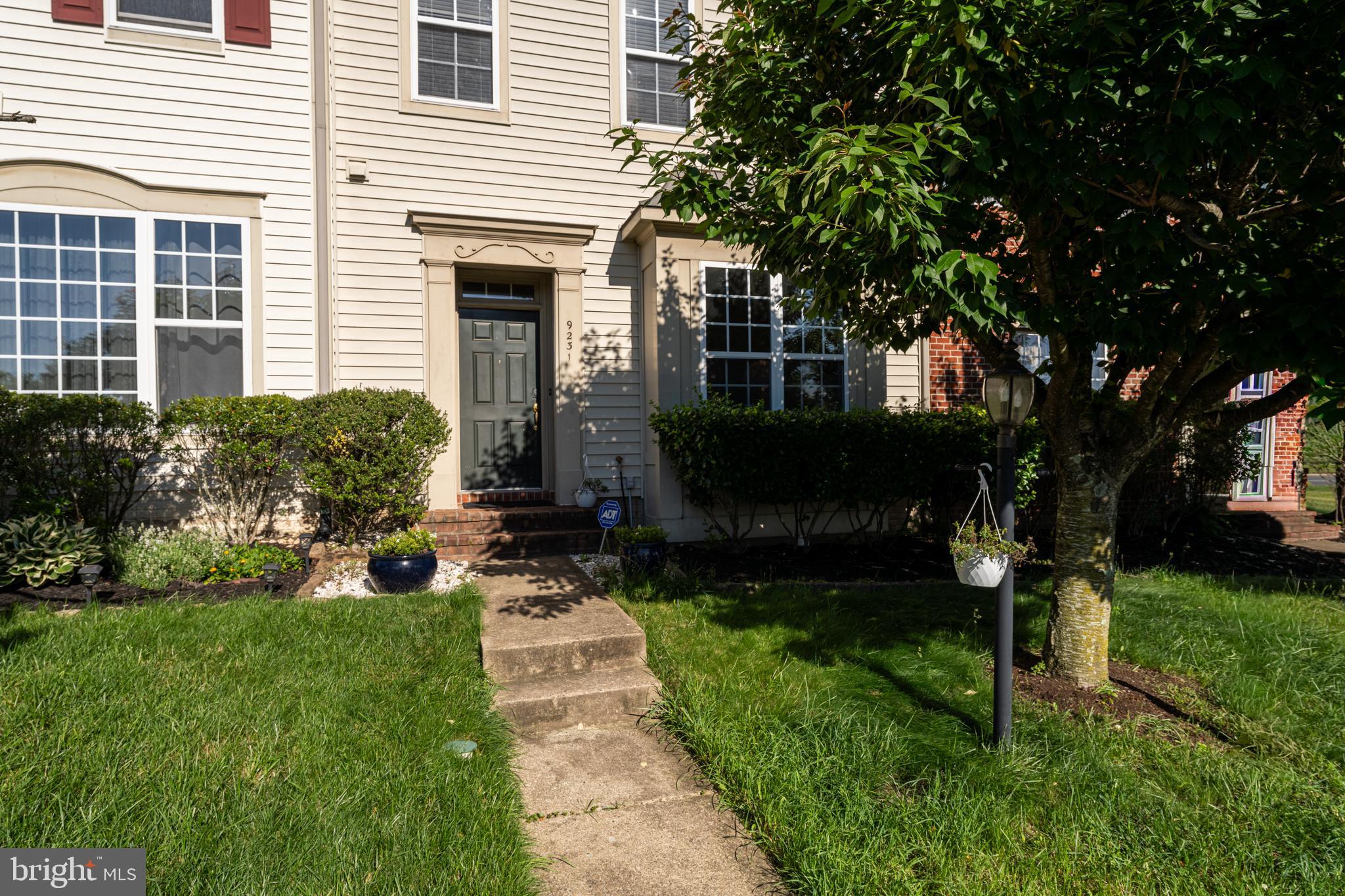 9231 Ribbon Falls Loop Bristow, VA 20136 - Photo 2 of 40 a front view of a house with garden
