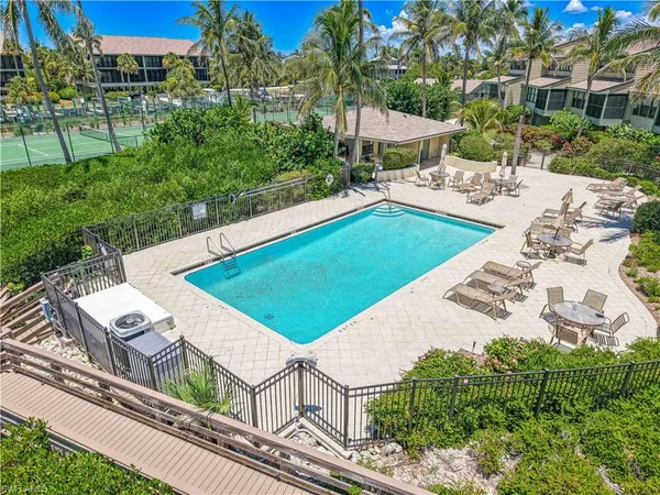 an aerial view of house with yard swimming pool and outdoor seating